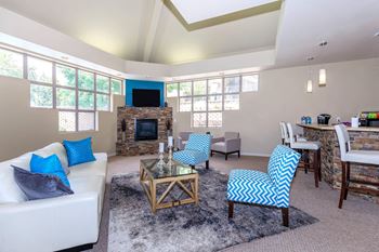 Clubhouse with a fireplace and a TV  at The Buttes Apartments Loveland, CO.