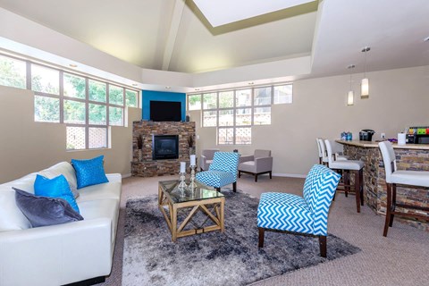a living room with a couch and chairs and a fireplace