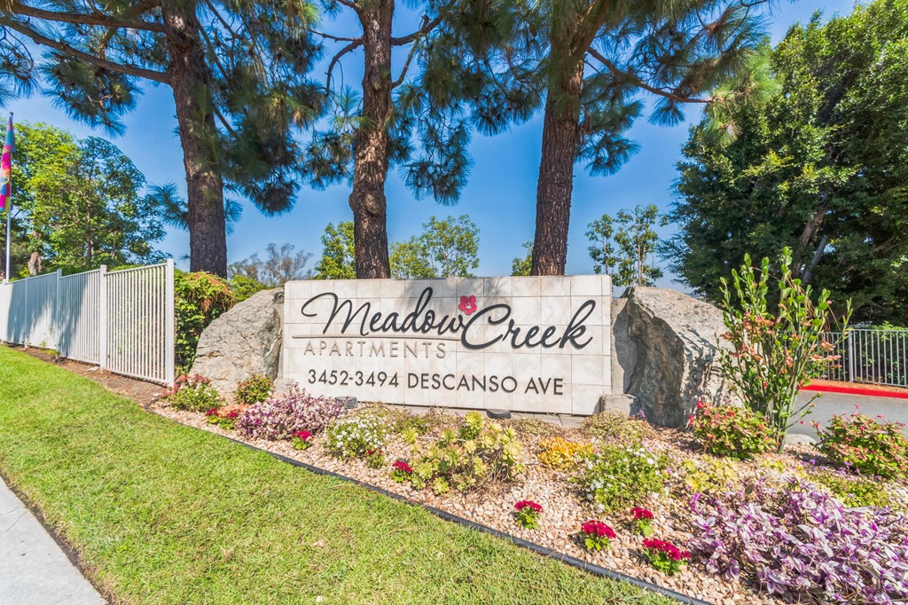 The Monument Sign at the property entrance of Meadow Creek Apartments in San Marcos, CA