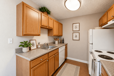 A kitchen with wooden cabinets and a white refrigerator.