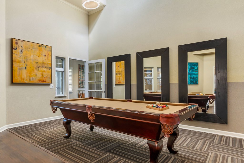 a games room with a pool table in a house