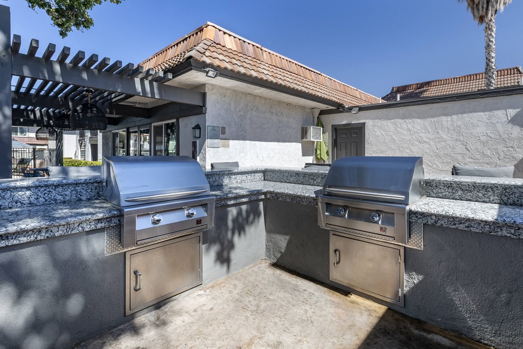 an outdoor kitchen with stainless steel appliances and granite counter tops at Sage Creek Apartment Homes, Simi Valley California