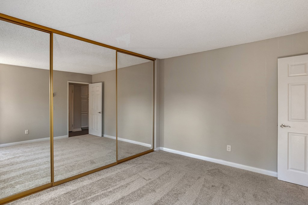 a bedroom with a large mirror at Scripps Poway Villas, Poway, CA