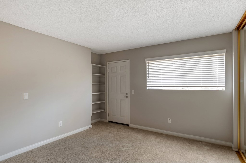 a bedroom with gray walls and a white door and window at Scripps Poway Villas, Poway