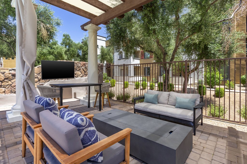 Enjoy our inviting patio furnished with comfy couches and a convenient table for your relaxation at Trevi Apartment Homes, Arizona, 85224