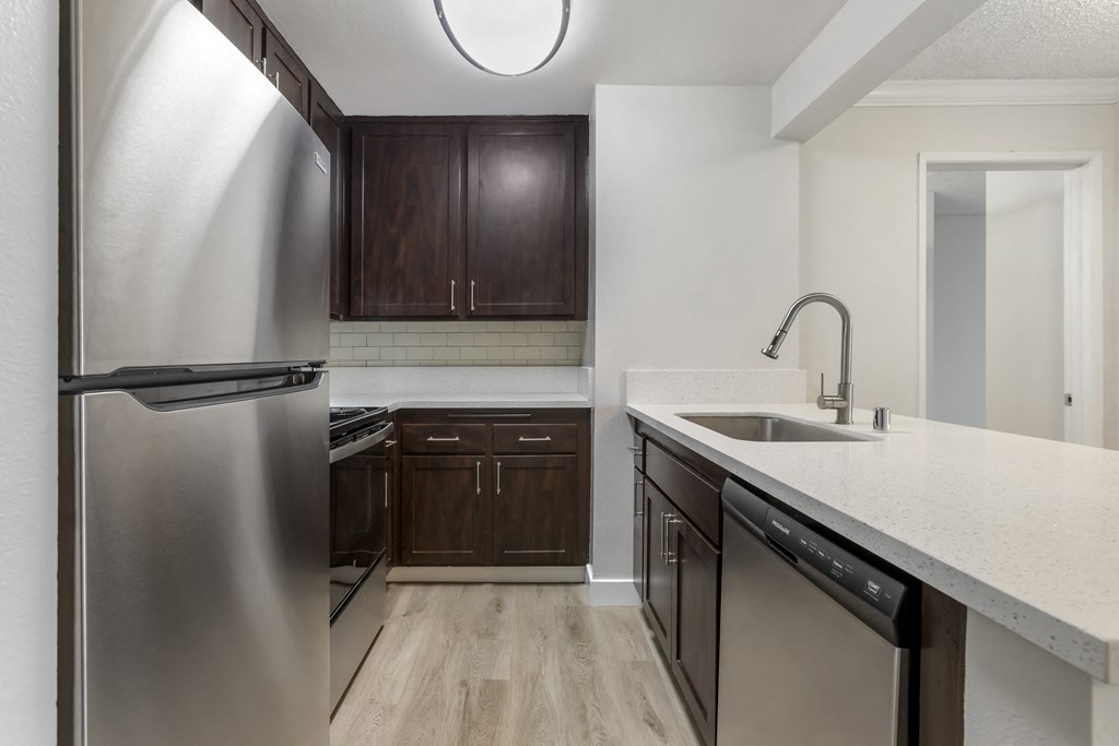 Modern elegance meets functionality in our remodeled kitchens, boasting sleek stainless steel appliances and pristine white countertops.