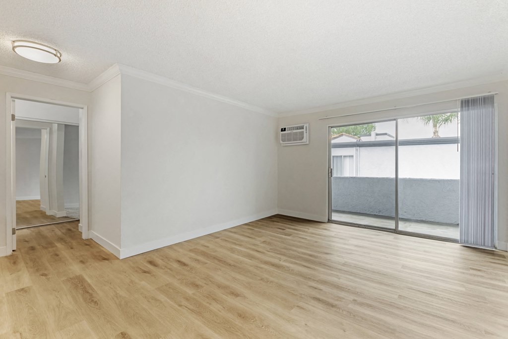 Cornerstone Apartments offer spacious living rooms with fresh flooring, seamlessly connected to nature through sliding glass doors leading to your private balcony.