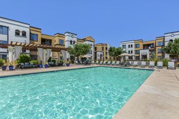 a swimming pool with apartments in the background at Trevi Apartment Homes, Arizona