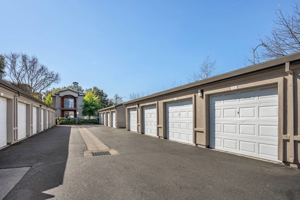 a long row of garages with white garage doors
