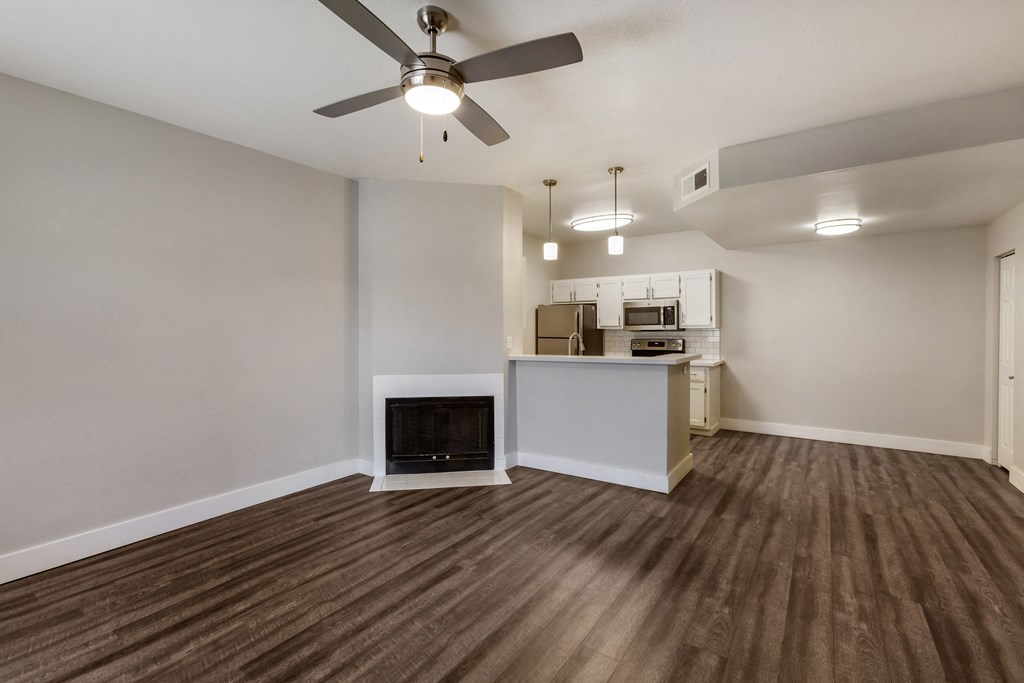 Enjoy the cozy ambiance of our living room, complete with a crackling fireplace at Boulders at Lookout Mountain Apartment Homes, Arizona 