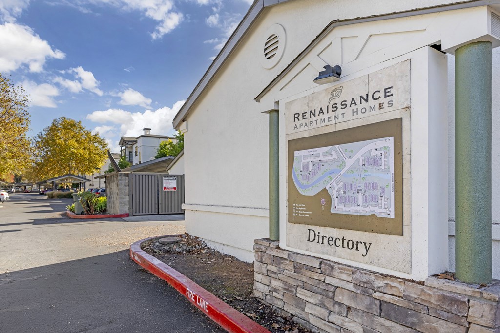 A sign for Renaissance Apartment Homes with a directory on it.