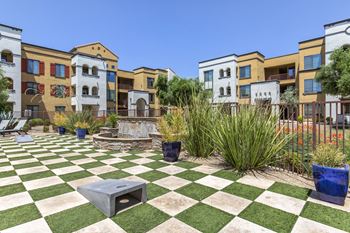 a green and white checkered picnic area in front of an apartment building at Trevi Apartment Homes, Arizona, 85224