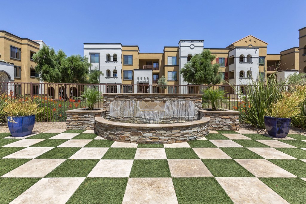 Experience serenity on our green checkered lawn, with a centerpiece fountain at Trevi Apartment Homes, Chandler, 85224