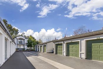 A row of green garage doors are on the right.
