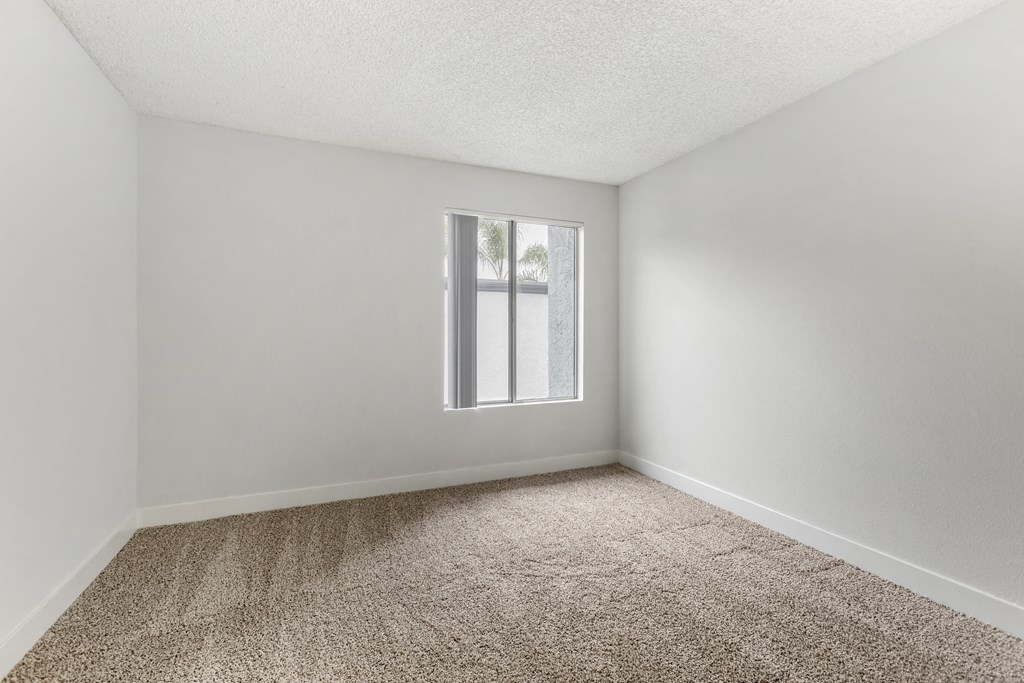 Discover modern comfort and serenity in our freshly renovated bedrooms, where pristine white walls meet plush new carpeting, creating your perfect sanctuary at Cornerstone Apartments.