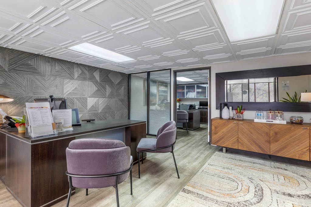 Step into Independence Plaza's chic lobby, featuring plush purple chairs and a welcoming leasing office—where luxury meets convenience.