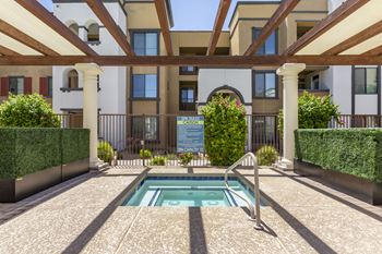 a swimming pool in the middle of a building with a pool at Trevi Apartment Homes, Chandler
