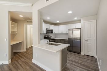 a kitchen with stainless steel appliances and a white counter top at Trevi Apartment Homes, Arizona, 85224