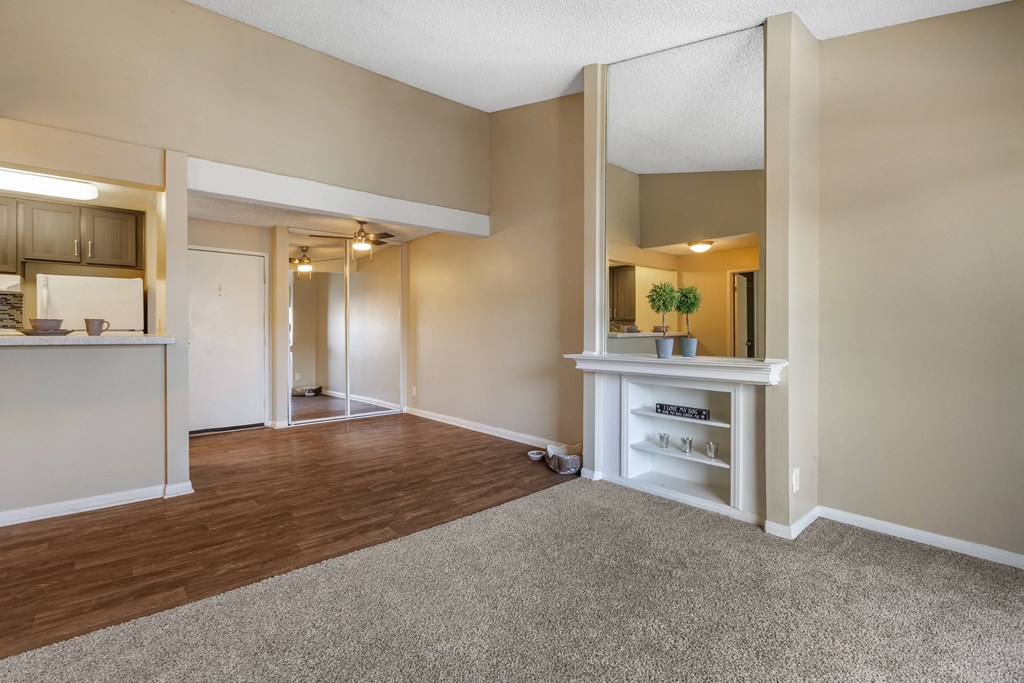 a living room with a kitchen in the background