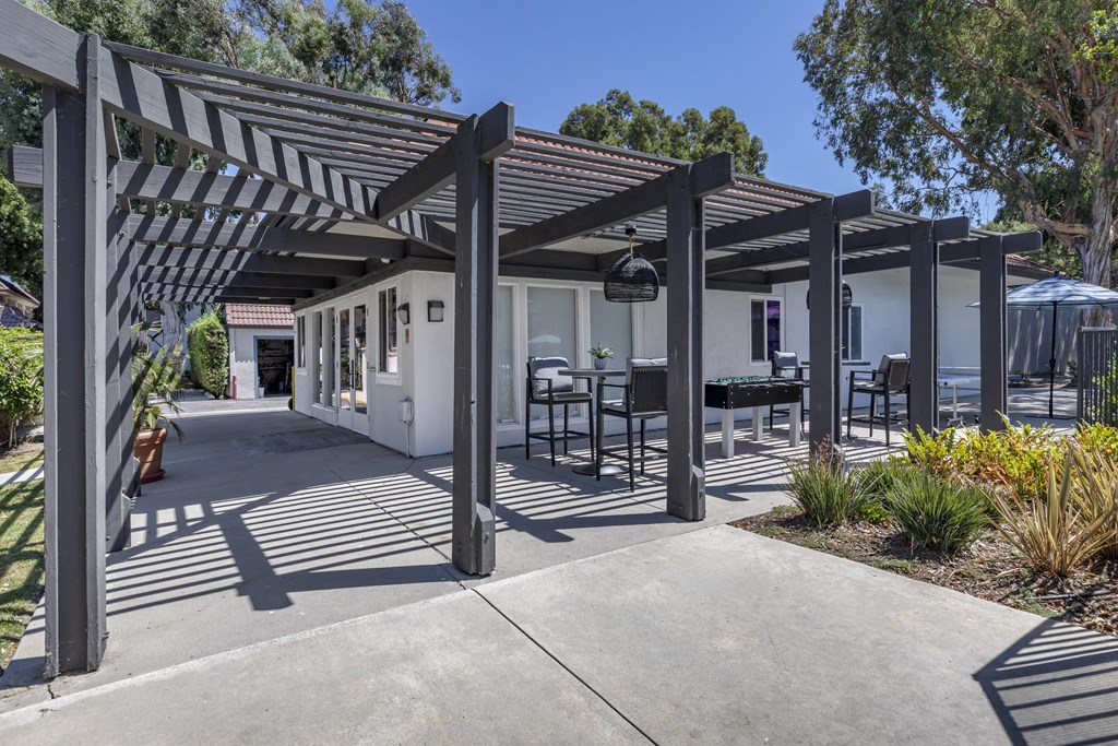 a patio with a pergola and tables and chairs at Sage Creek Apartment Homes, California, 93063