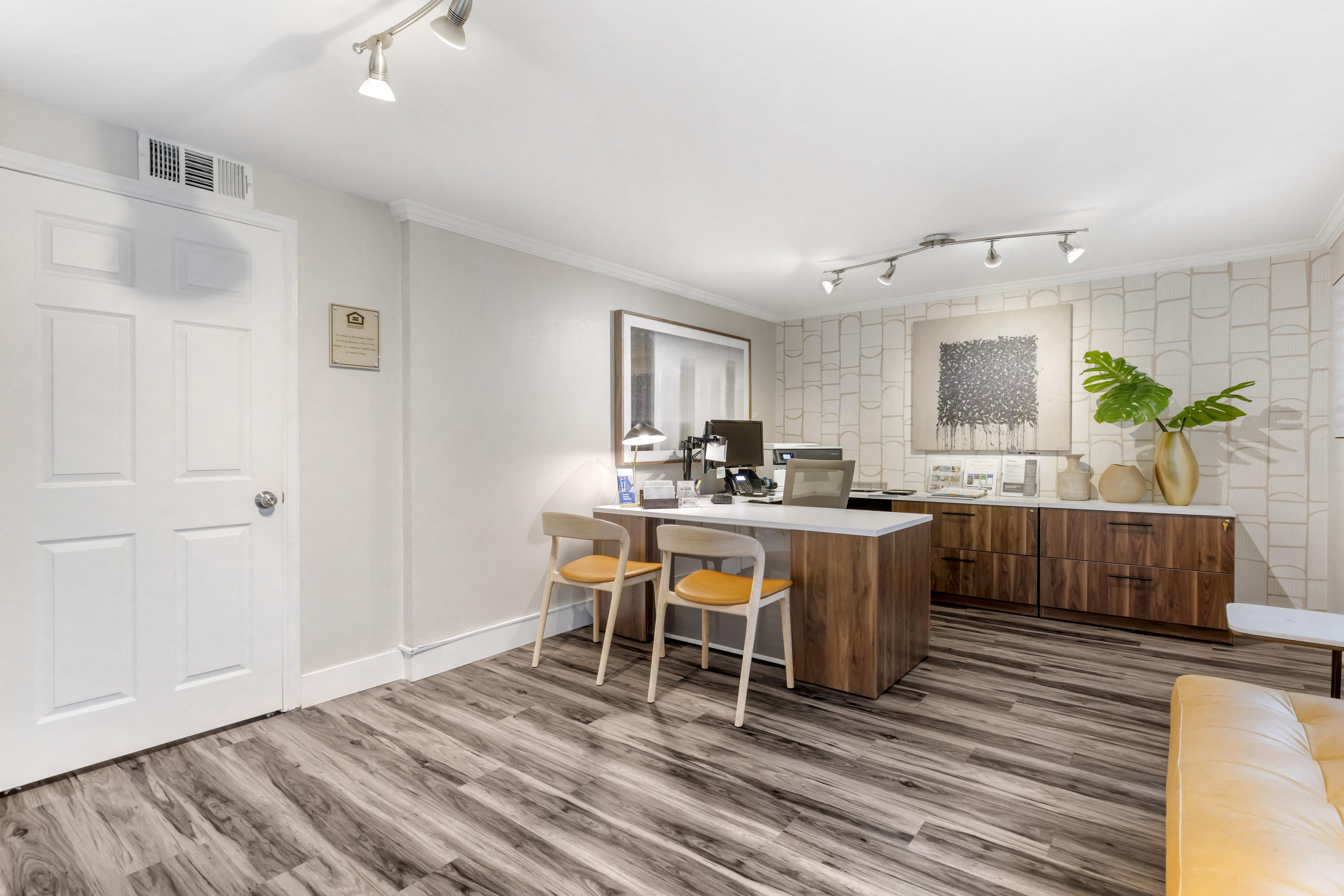 a kitchen and living room with a white counter and wood flooring