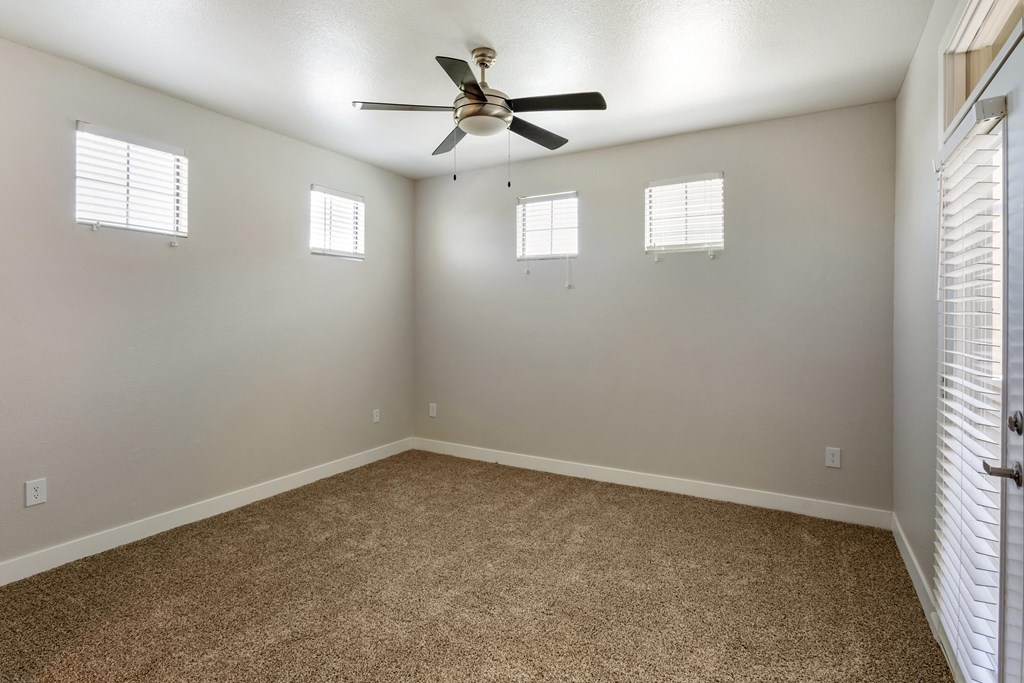 Welcome to your serene bedroom, complete with a ceiling fan and bright windows for a perfect blend of comfort and natural light at Trevi Apartment Homes, Chandler, AZ, 85224