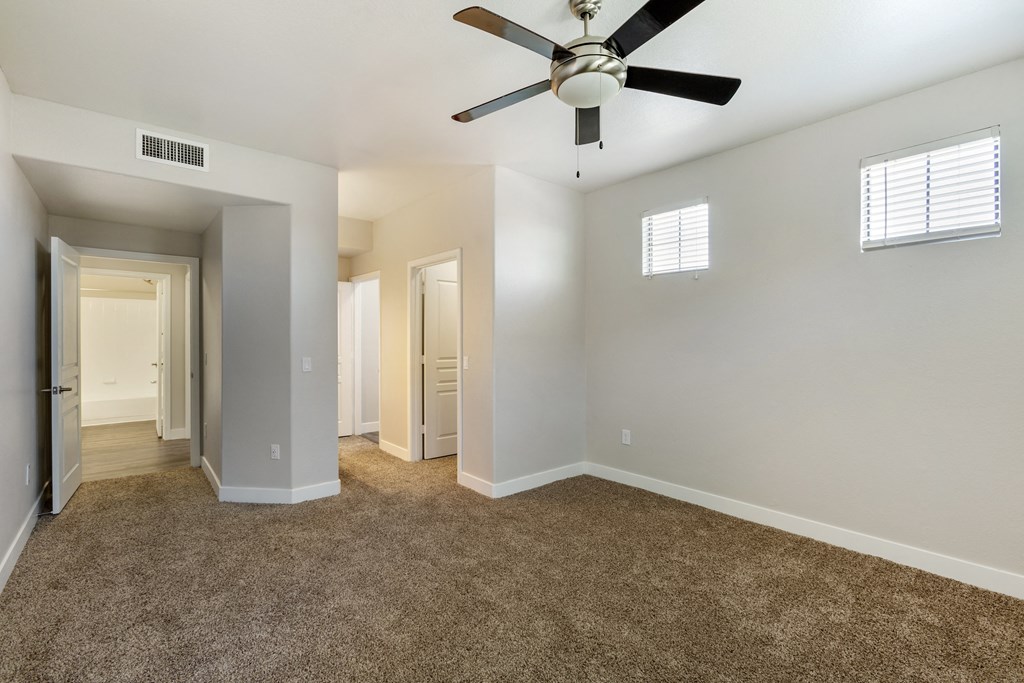 Relax in our carpeted bedroom, complete with a soothing ceiling fan at Trevi Apartment Homes, Chandler, 85224
