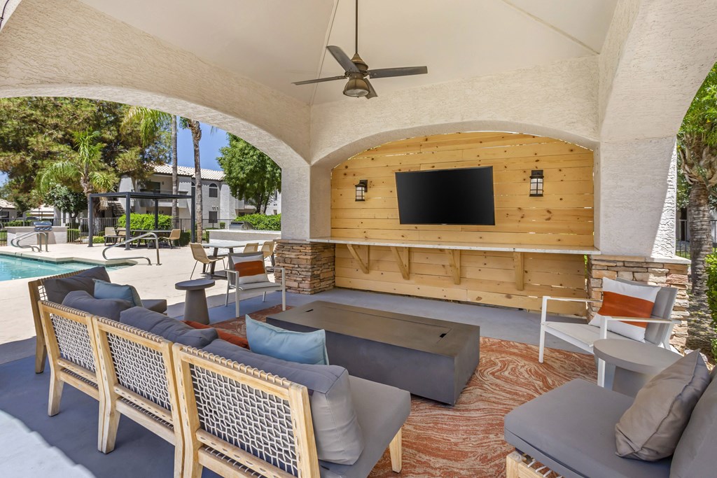 Relax in style by the pool with our comfy seating and entertainment at Boulders at Lookout Mountain Apartment Homes, Phoenix, AZ 85022