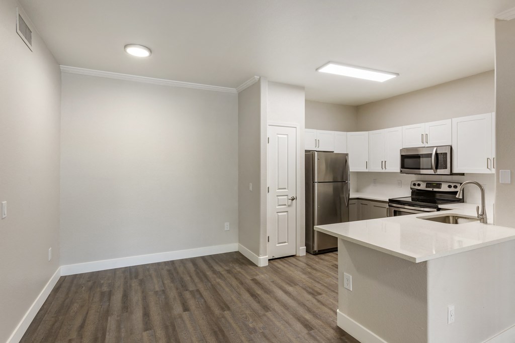 Modern kitchen with white cabinetry and stainless steel appliances at Trevi Apartment Homes, Chandler