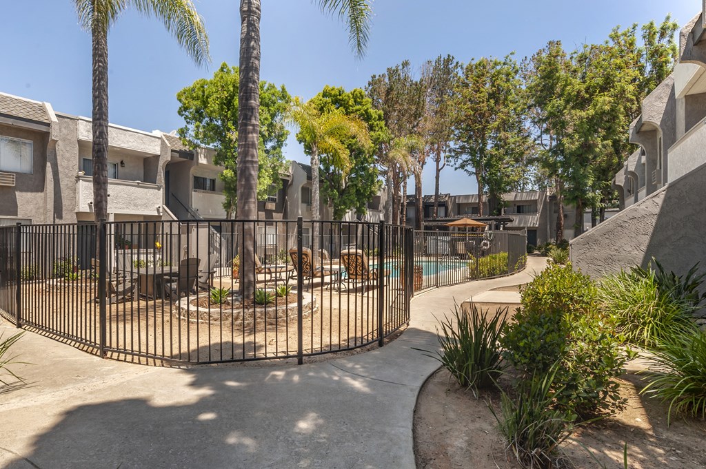 a gated community with palm trees and a pool at Scripps Poway Villas, Poway