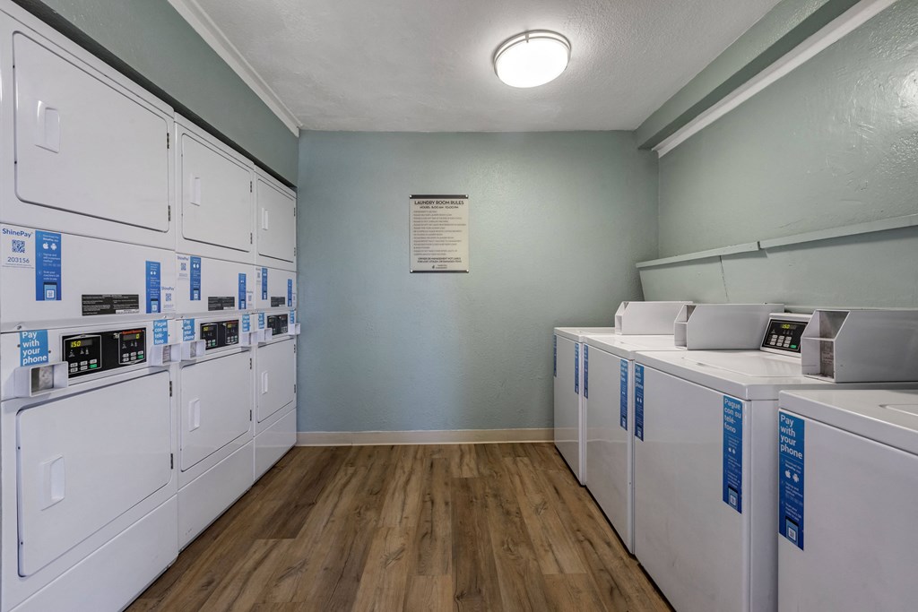 a laundry room with washers and dryers