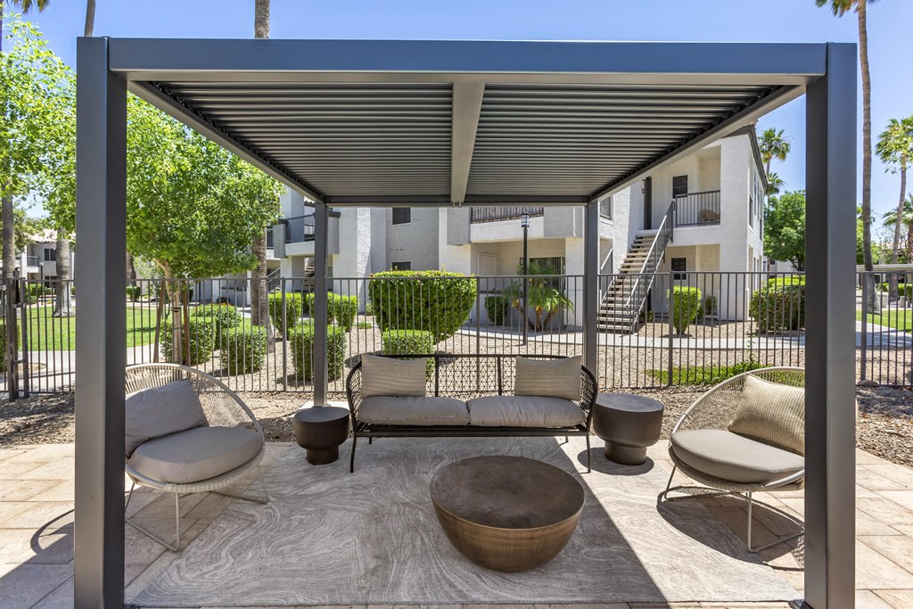 Comfortable outdoor seating by the pool at Boulders at Lookout Mountain Apartment Homes, Phoenix, AZ