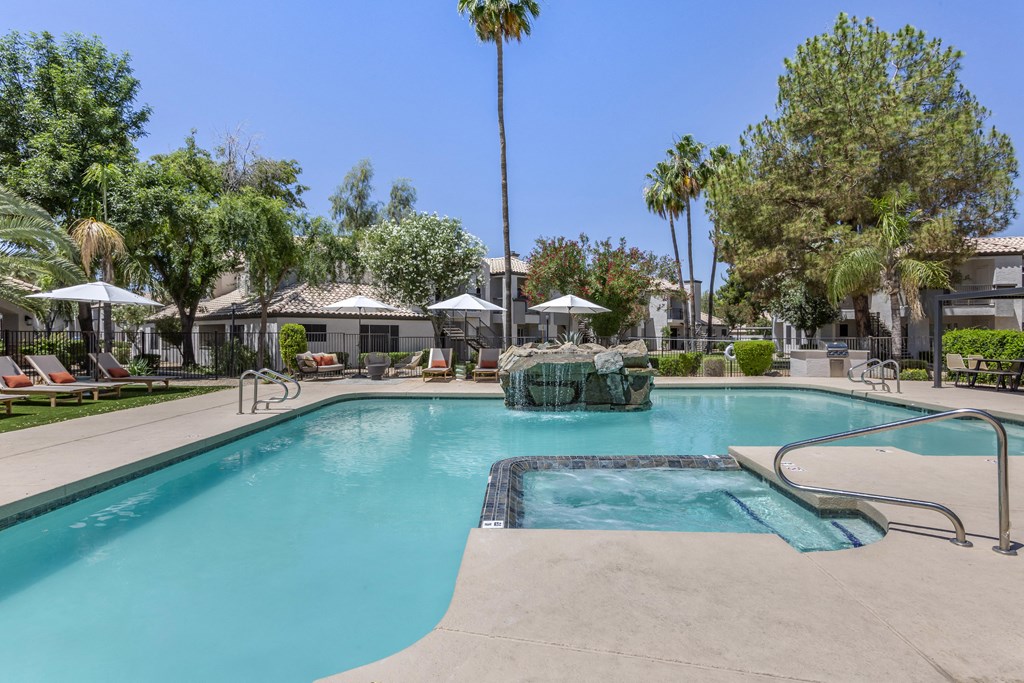 Mountain's pool oasis, complete with a stunning fountain and palm tree backdrop at Boulders at Lookout Mountain Apartment Homes, Phoenix, AZ 85022