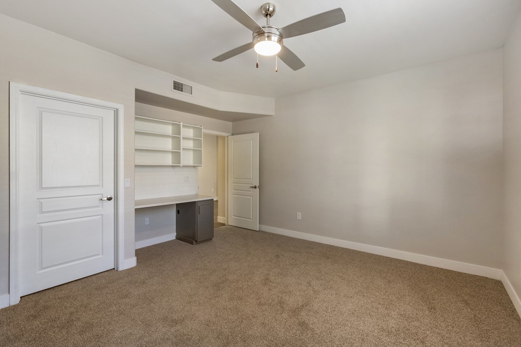 Enjoy a serene space with a desk for work and a ceiling fan for comfort at Trevi Apartment Homes, Arizona