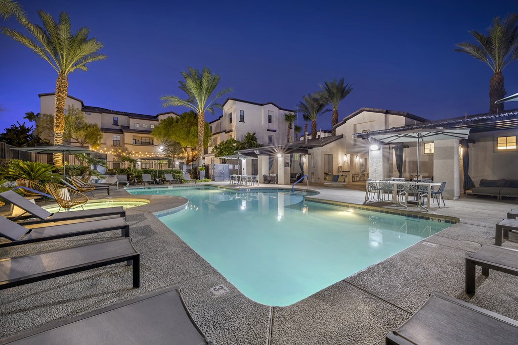 As the sun sets and twilight takes over, the pool transforms into a serene oasis, with ambient lighting enhancing the luxurious feel of the surroundings.