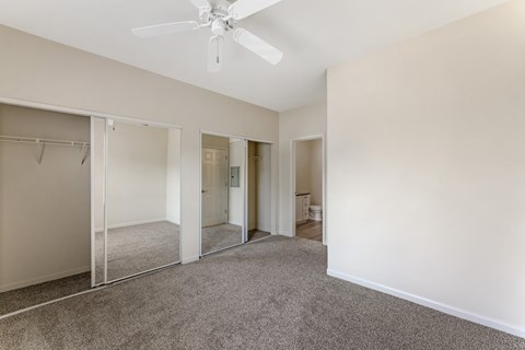 Bedrooms at Ascent at the Galleria come with cozy carpeting and ceiling fans, providing comfort and a relaxing atmosphere in every home.