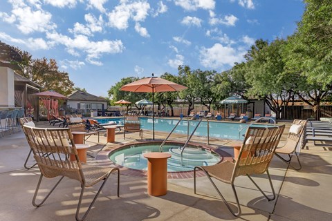 A pool area with chairs and umbrellas is shown.