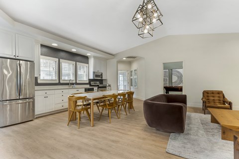 A modern kitchen with a dining table and chairs.