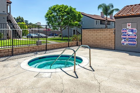 A pool with a diving board in the middle of a backyard.