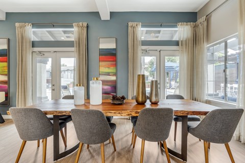 The clubhouse includes a spacious table with seating for up to eight people—perfect for group gatherings, meetings, or enjoying coffee and conversation with friends and neighbors.