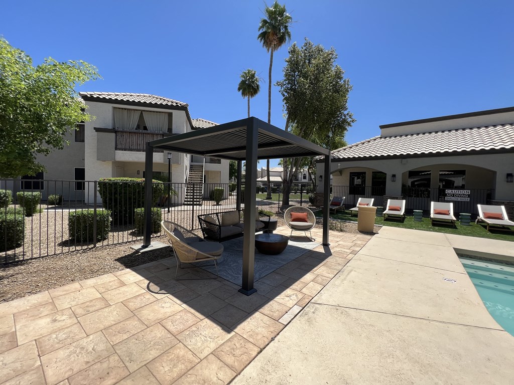 Relax on our patio by the pool, right outside our building at Boulders at Lookout Mountain Apartment Homes, Phoenix Arizona