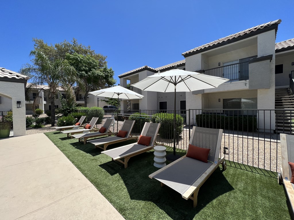Lounge in luxury by our pool deck with plenty of comfy chairs for ultimate relaxation at Boulders at Lookout Mountain Apartment Homes, Phoenix, AZ 85022