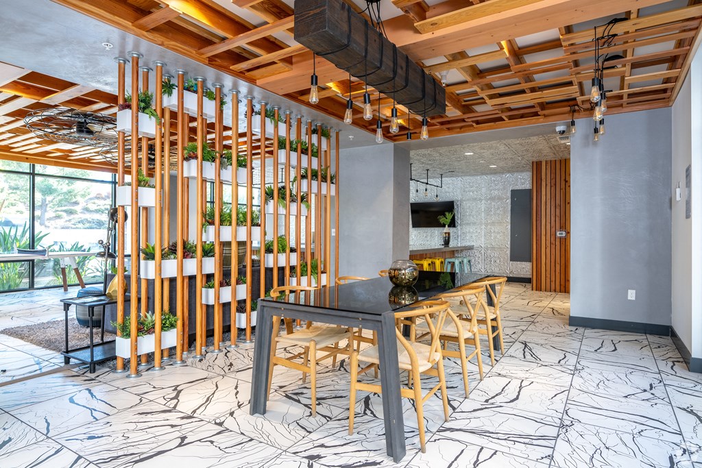 A modern kitchen with a wooden table and chairs.