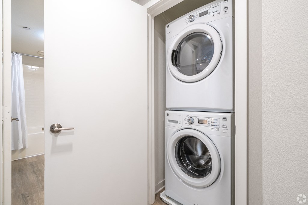 A white washing machine and dryer in a small laundry room.