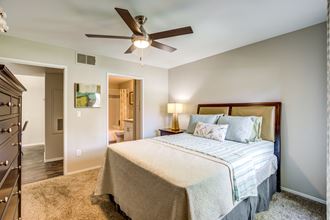 3 BR Apartments in Spring Valley NV - Aviara - Cozy Bedroom With a Soft Bed, Carpet Flooring, a Nightstand, a Dresser, a Ceiling Fan, and a Bathroom