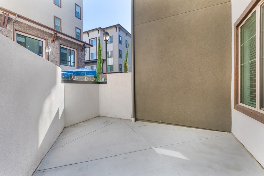 a patio with a wall and a door to a balcony at Metro Gateway, Riverside, CA, 92503