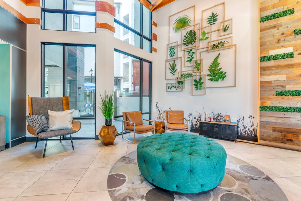 a living room with a turquoise ottoman in the center of it at Metro Gateway, California