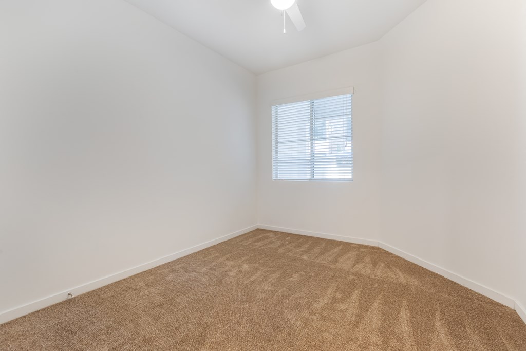 an empty room with carpet and a window at Metro Gateway, Riverside, 92503