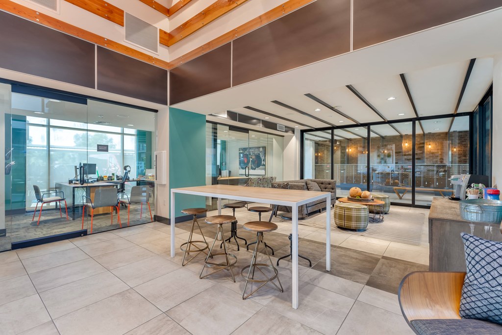 the lobby of a building with tables and chairs at Metro Gateway, Riverside, CA