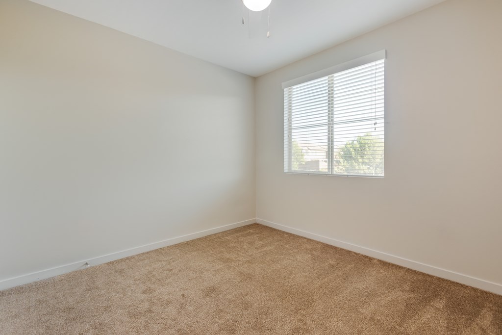 an empty room with carpet and a window at Metro Gateway, California